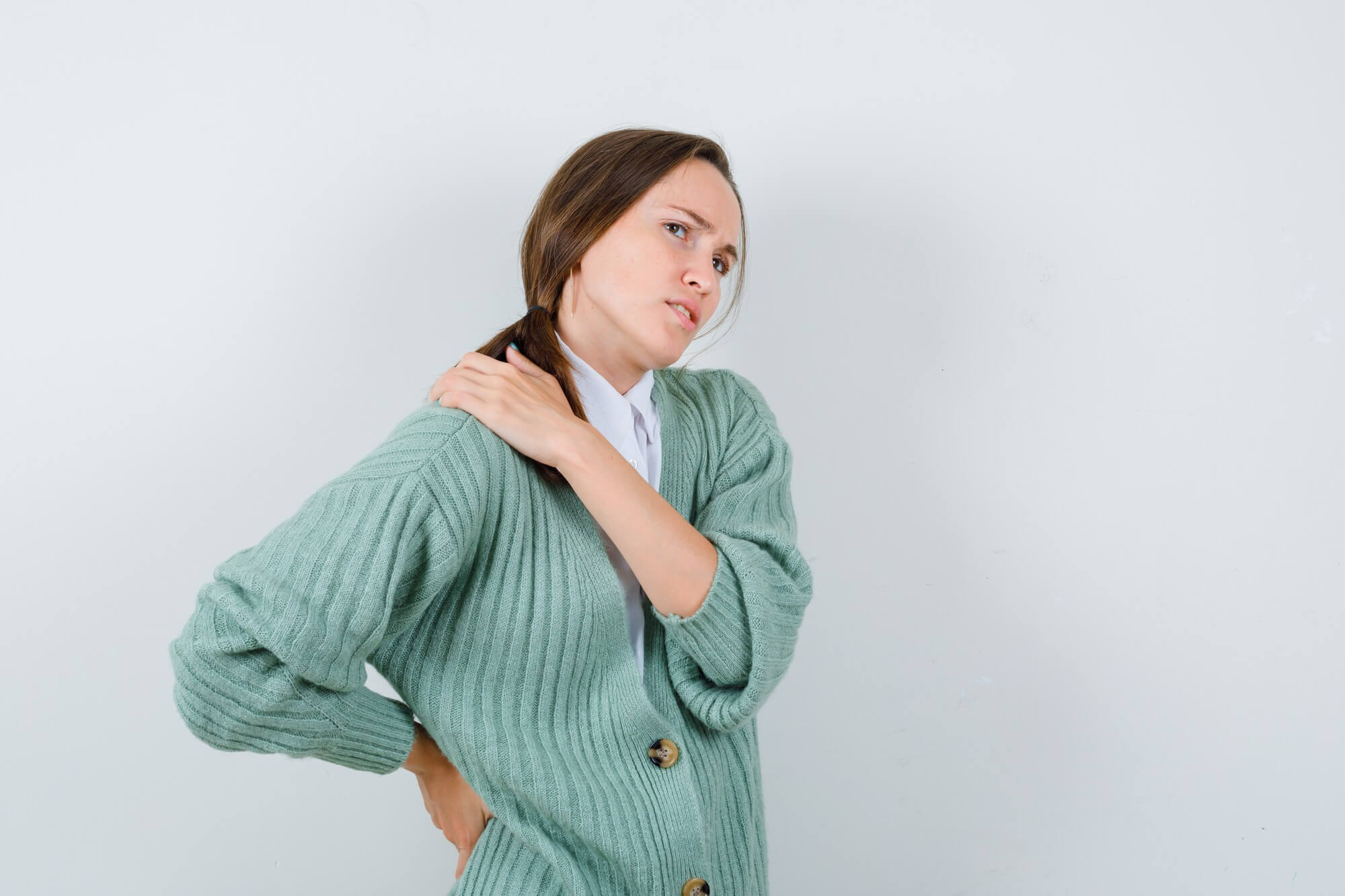 young-woman-blouse-cardigan-suffering-from-backache-looking-fatigued-front-view (1)